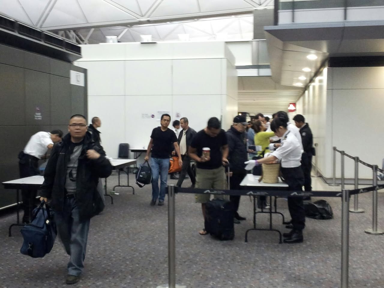 US reaches out to us in Hong Kong airport, and molests us for a second time, at the gate. No photos allowed, citizen!
